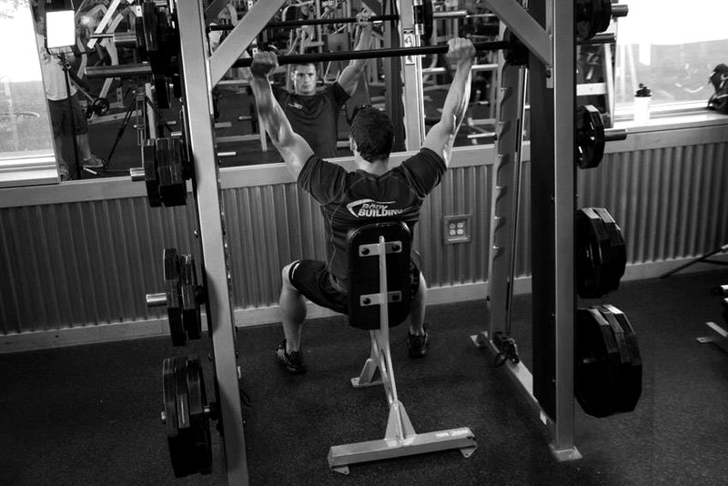 Smith Machine Overhead Shoulder Press — end position demonstration photo