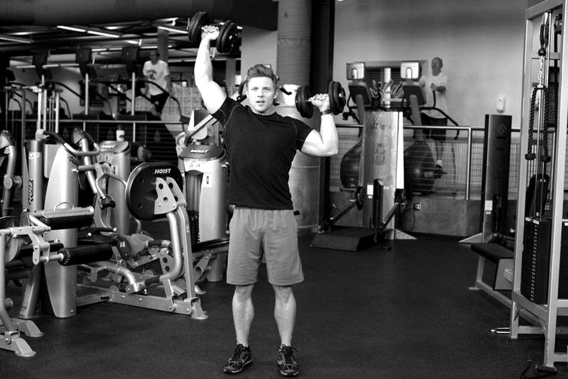 Standing Alternating Dumbbell Press — end position demonstration photo