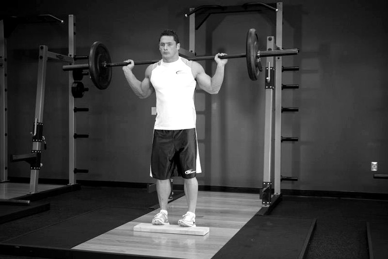 Standing Barbell Calf Raise — end position demonstration photo