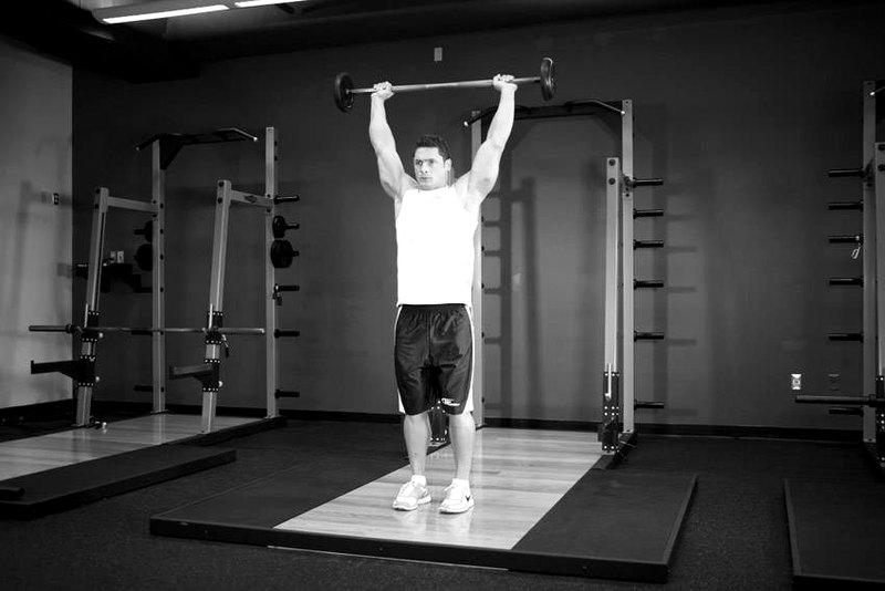 Standing Barbell Press Behind Neck — end position demonstration photo