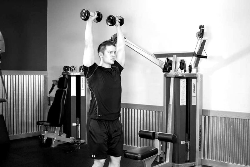 Standing Dumbbell Press — end position demonstration photo