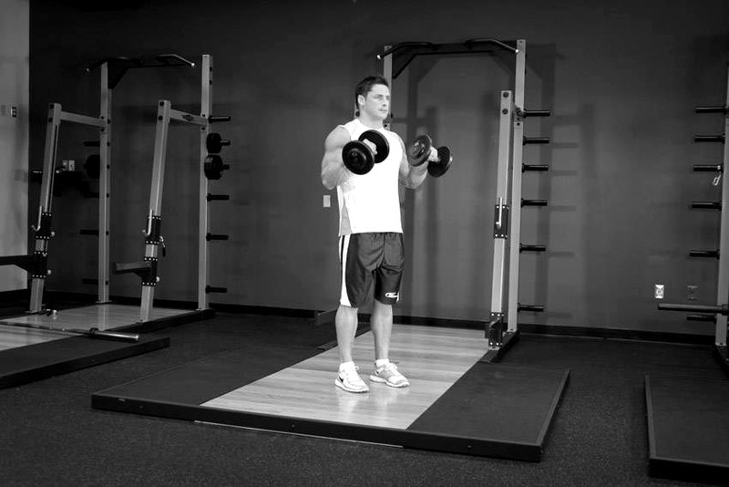 Standing Dumbbell Reverse Curl — end position demonstration photo