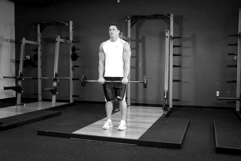 Standing Front Barbell Raise Over Head — start position demonstration photo