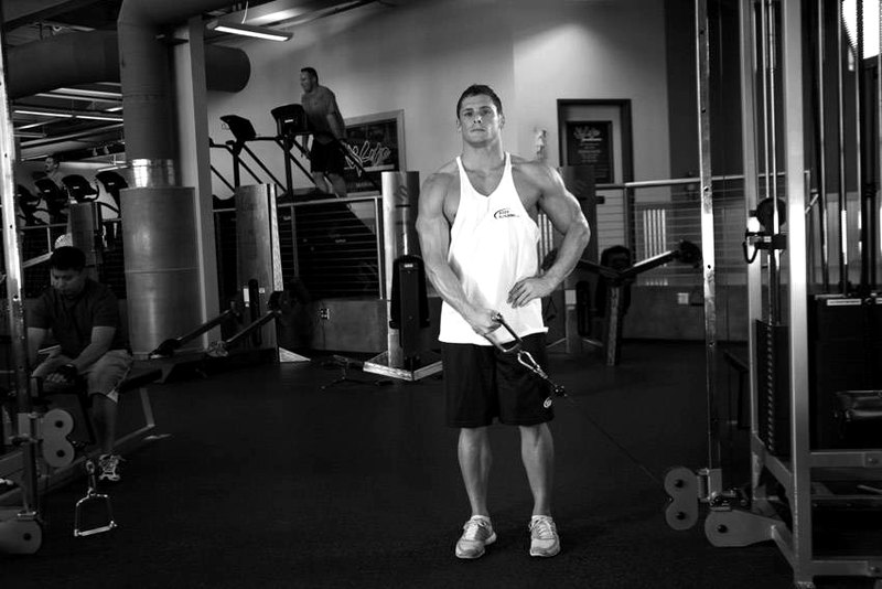 Standing Low-Pulley Deltoid Raise — end position demonstration photo