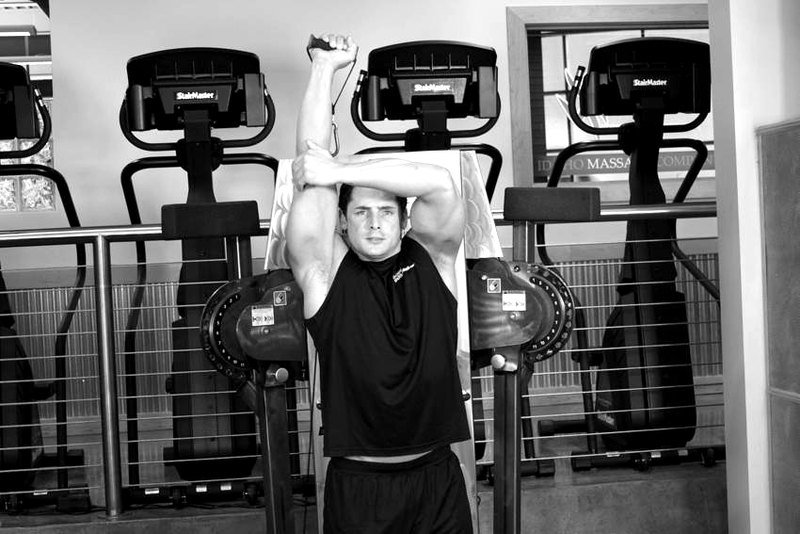 Standing Low-Pulley One-Arm Triceps Extension — end position demonstration photo