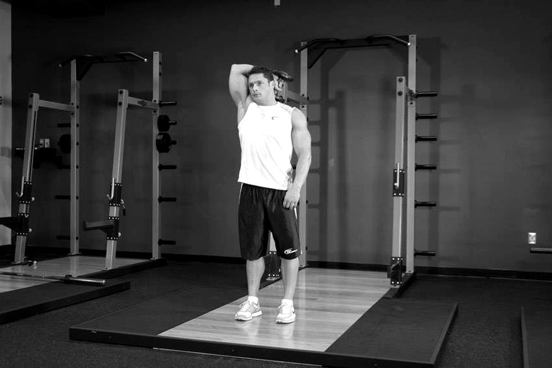 Standing One-Arm Dumbbell Triceps Extension — end position demonstration photo