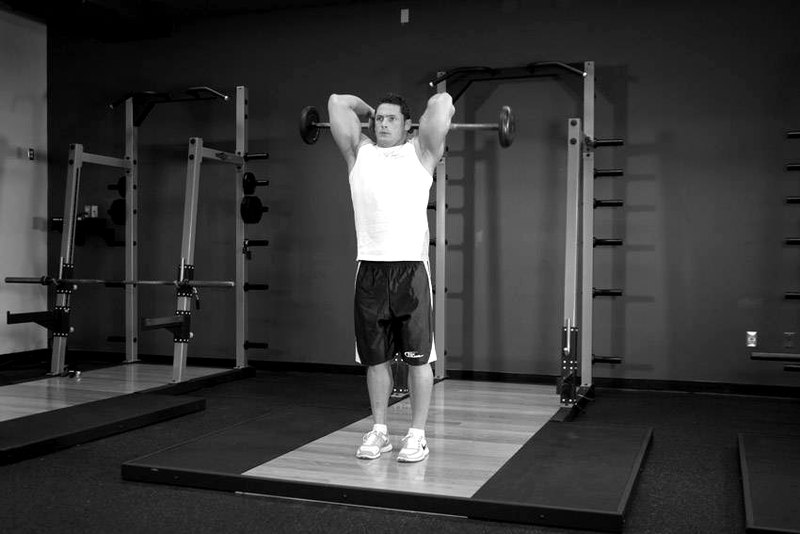 Standing Overhead Barbell Triceps Extension — start position demonstration photo