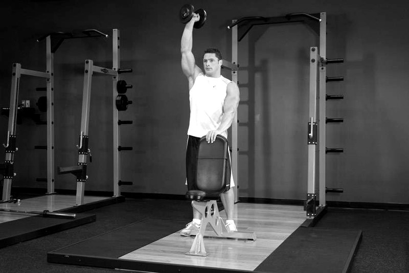 Standing Palm-In One-Arm Dumbbell Press — end position demonstration photo