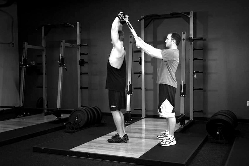 Standing Towel Triceps Extension — end position demonstration photo