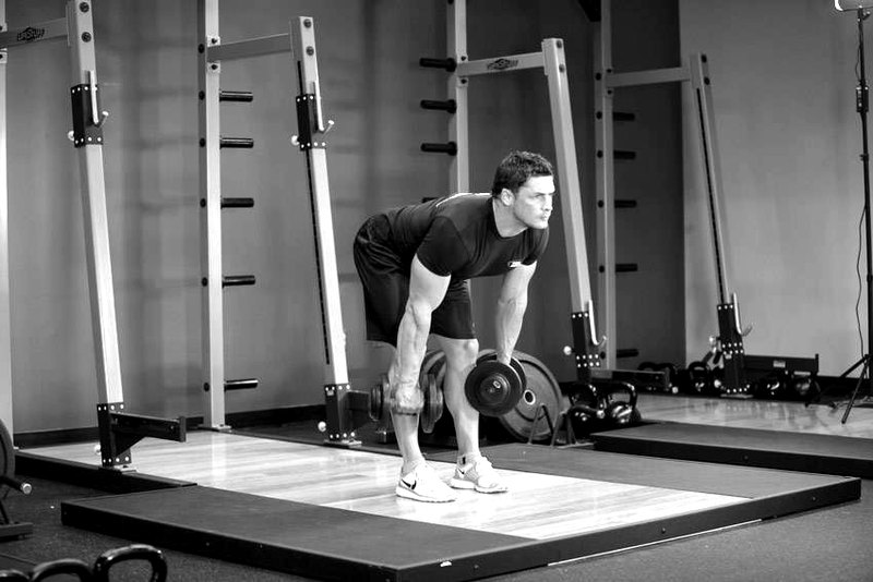 Stiff-Legged Dumbbell Deadlift — end position demonstration photo