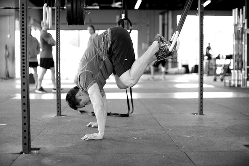 Suspended Reverse Crunch — end position demonstration photo
