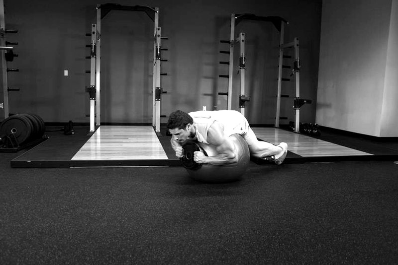 Weighted Ball Hyperextension — start position demonstration photo