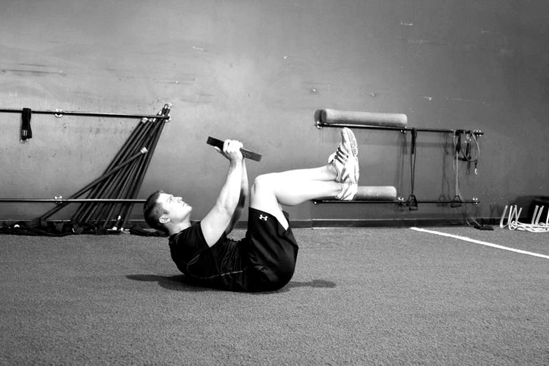 Weighted Crunches — end position demonstration photo