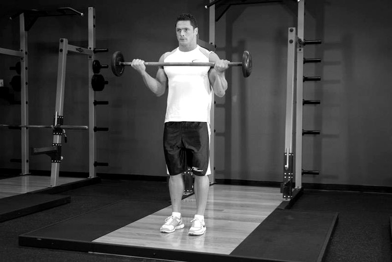 Wide-Grip Standing Barbell Curl — end position demonstration photo