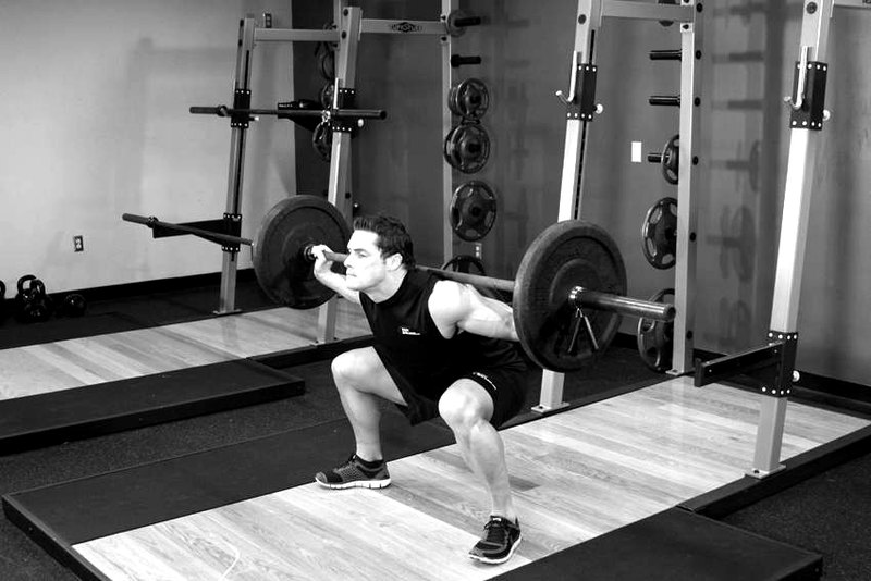 Wide Stance Barbell Squat — end position demonstration photo